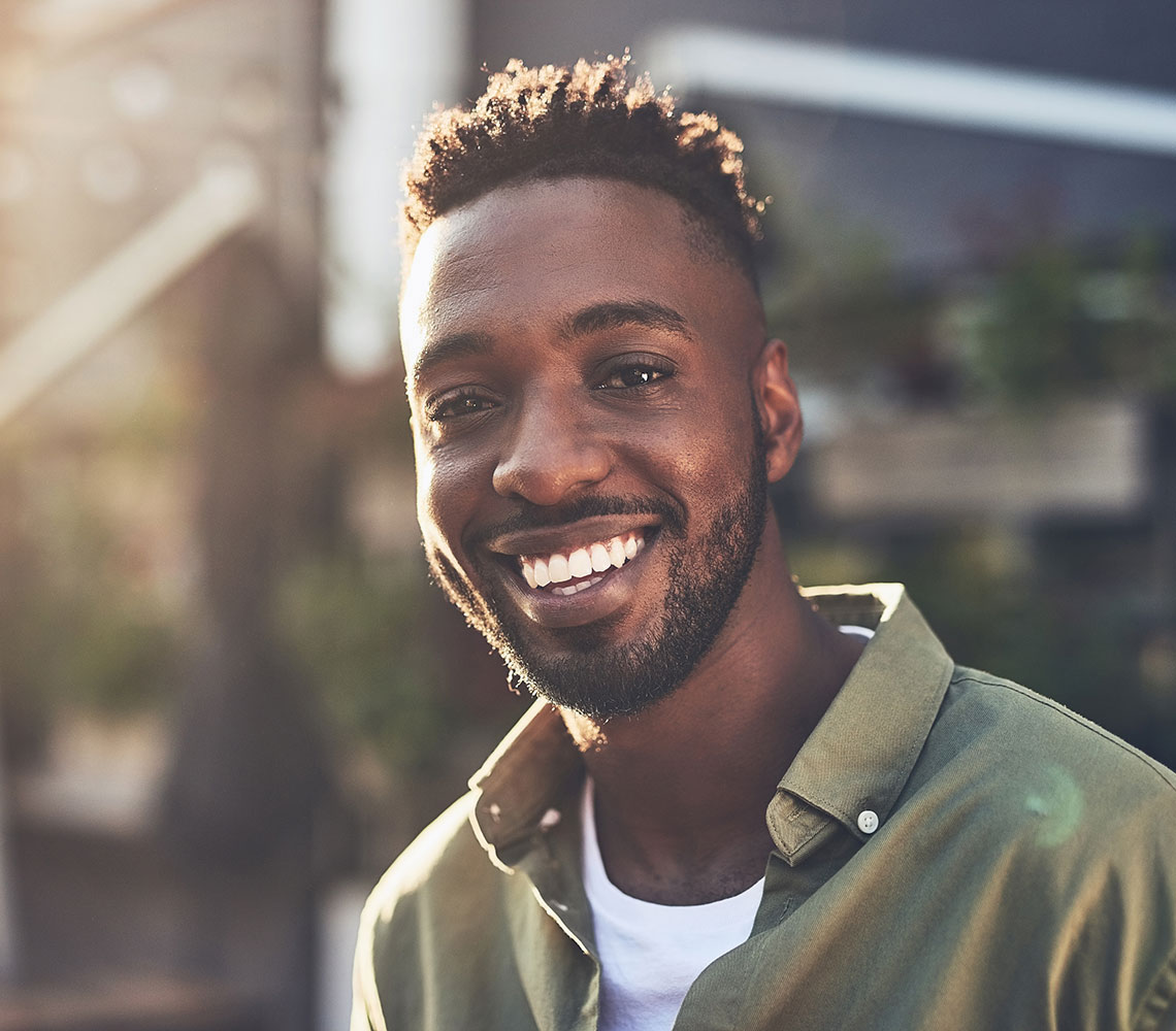 Smiling happy man in green shirt